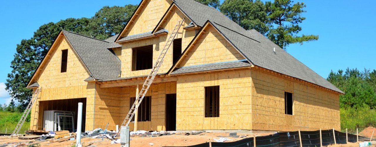 ladders-leaning-against-house-in-front-of-trees-209282